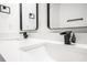 Bathroom vanity featuring a double sink with black faucet, white countertop and black trimmed mirrors at 904 Fairburn Nw Pl, Atlanta, GA 30331