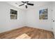 Bedroom features hardwood floors, white walls, ceiling fan, and a pair of large, bright windows at 904 Fairburn Nw Pl, Atlanta, GA 30331