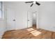 Bedroom showcasing hardwood floors, a ceiling fan, with an ensuite bathroom and adjacent closet at 904 Fairburn Nw Pl, Atlanta, GA 30331