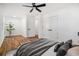 Airy bedroom featuring stylish ceiling fan, hardwood floors, and neutral decor at 904 Fairburn Nw Pl, Atlanta, GA 30331