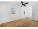 Bright bedroom with hardwood floors, ceiling fan, and two windows at 904 Fairburn Nw Pl, Atlanta, GA 30331