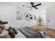 Bright bedroom with hardwood floors, ceiling fan, two windows, and decorative artwork at 904 Fairburn Nw Pl, Atlanta, GA 30331