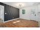 Dining room with stylish black accent wall, hardwood floors, and bright white walls at 904 Fairburn Nw Pl, Atlanta, GA 30331