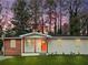 Charming single-story home with a tidy front lawn, a vibrant orange door, and wooden porch columns at 904 Fairburn Nw Pl, Atlanta, GA 30331