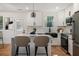 Modern kitchen with a center island, white cabinets, and stainless steel appliances at 904 Fairburn Nw Pl, Atlanta, GA 30331