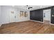 Bright living room featuring hardwood floors, modern lighting, and a stylish accent wall at 904 Fairburn Nw Pl, Atlanta, GA 30331