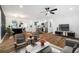Bright, open living space featuring hardwood floors seamlessly connecting the living room, dining area, and modern kitchen at 904 Fairburn Nw Pl, Atlanta, GA 30331