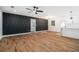 Spacious living room with stylish black accent wall, hardwood floors, and bright white walls at 904 Fairburn Nw Pl, Atlanta, GA 30331
