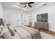 Bright main bedroom with tray ceiling, fan, tv and ensuite bathroom at 904 Fairburn Nw Pl, Atlanta, GA 30331