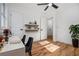 Bright home office with hardwood floors, floating shelves, and a modern ceiling fan fixture at 904 Fairburn Nw Pl, Atlanta, GA 30331