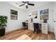 Well-lit office space with a desk by two windows, hardwood floors, and a black ceiling fan at 904 Fairburn Nw Pl, Atlanta, GA 30331