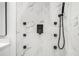 Close-up of modern shower fixtures, including a rainfall showerhead and body sprayers on marble tile at 904 Fairburn Nw Pl, Atlanta, GA 30331