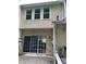 Home exterior featuring a patio with sliding glass doors and double-hung windows above at 211 Buckland Dr, Alpharetta, GA 30022