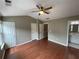 Bedroom featuring hardwood floors, neutral walls, and a lighted ceiling fan at 211 Buckland Dr, Alpharetta, GA 30022