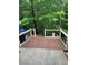 Back deck with view of wooded area, featuring a well-maintained deck and black aluminum railings at 211 Buckland Dr, Alpharetta, GA 30022