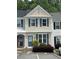 Charming townhome with blue shutters and manicured landscaping for a cozy curb appeal at 211 Buckland Dr, Alpharetta, GA 30022