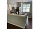 The updated kitchen features white cabinets, stainless steel appliances and a practical breakfast bar at 211 Buckland Dr, Alpharetta, GA 30022