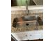 A clean stainless steel kitchen sink, countertop, and cabinetry at 211 Buckland Dr, Alpharetta, GA 30022