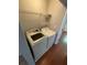 Laundry area with a washer, dryer, wire shelving, and wood look floors at 211 Buckland Dr, Alpharetta, GA 30022