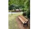 A bench offers a place to rest near the Devonshire neighborhood sign at 211 Buckland Dr, Alpharetta, GA 30022