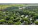 Lush aerial view showcasing tree-lined community and winding lake, offering a sense of serenity at 448 Teal Ct, Roswell, GA 30076