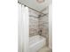 Updated bathroom features tiled shower and a tub at 448 Teal Ct, Roswell, GA 30076