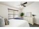 Bright bedroom with ceiling fan, modern rug, and large window views at 448 Teal Ct, Roswell, GA 30076