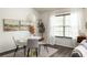 Bright dining area featuring a round table, modern chairs, and a large window for natural light at 448 Teal Ct, Roswell, GA 30076