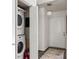 Well-lit entryway featuring a stacked washer and dryer and a neutral rug at 448 Teal Ct, Roswell, GA 30076