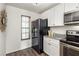 A bright kitchen is upgraded with granite countertops and stainless steel appliances at 448 Teal Ct, Roswell, GA 30076