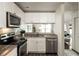 Well-lit kitchen featuring modern appliances, stylish countertops, and a convenient layout at 448 Teal Ct, Roswell, GA 30076