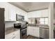 Modern kitchen with stainless steel appliances, granite countertops, and ample cabinet space at 448 Teal Ct, Roswell, GA 30076