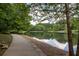 Picturesque lake view with a paved walking path alongside, surrounded by lush trees at 448 Teal Ct, Roswell, GA 30076
