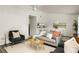 Cozy living area with a modern sofa, stylish chairs, and a view into the dining space at 448 Teal Ct, Roswell, GA 30076