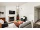 Open-concept living room with a fireplace, hardwood floors, and plenty of natural light at 448 Teal Ct, Roswell, GA 30076
