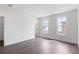 Bedroom showcasing two windows, hardwood floors, and neutral walls at 507 Motivation Nw Cir, Atlanta, GA 30309