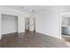 Large bedroom with pristine white walls, wooden floors, and access to an attached bathroom at 507 Motivation Nw Cir, Atlanta, GA 30309