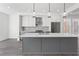 Modern kitchen features a large island with pendant lighting, stainless steel appliances, and sleek cabinetry at 507 Motivation Nw Cir, Atlanta, GA 30309