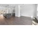 Open-concept living space with wood floors, a stylish kitchen island, and large windows for ample sunlight at 507 Motivation Nw Cir, Atlanta, GA 30309