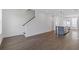 Open living space featuring wood floors, a kitchen island with seating, and an adjacent staircase at 507 Motivation Nw Cir, Atlanta, GA 30309