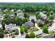 Brick home on waterfront lot features mature trees, an arched garden entry, and a pristine lawn at 5070 Riverlake Dr, Peachtree Corners, GA 30097
