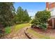 Picturesque backyard with stone pathway leading to a lush lawn and a charming view of the home at 5070 Riverlake Dr, Peachtree Corners, GA 30097