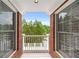The balcony has a white railing overlooking a treed area at 5070 Riverlake Dr, Peachtree Corners, GA 30097