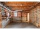 Unfinished basement features exposed framing and a small window at 5070 Riverlake Dr, Peachtree Corners, GA 30097