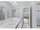 Well-lit bathroom featuring a double sink vanity and a separate glass-enclosed shower at 5070 Riverlake Dr, Peachtree Corners, GA 30097