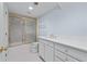 Bright bathroom featuring a tiled shower and tub, and a sink with white cabinets at 5070 Riverlake Dr, Peachtree Corners, GA 30097