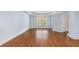 Bedroom with light blue walls, hardwood floors and window overlooking backyard at 5070 Riverlake Dr, Peachtree Corners, GA 30097