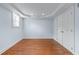 Cozy bedroom featuring hardwood floors, a window, and a closet at 5070 Riverlake Dr, Peachtree Corners, GA 30097