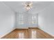 A well-lit bedroom features hardwood floors, crown molding, and bright windows with views at 5070 Riverlake Dr, Peachtree Corners, GA 30097