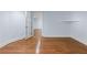 Bright bedroom with hardwood floors, white trim, and an open glass door at 5070 Riverlake Dr, Peachtree Corners, GA 30097